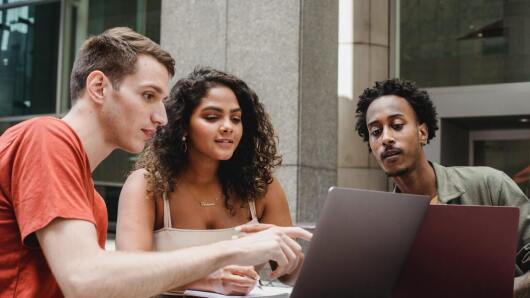 Three persons with a laptop